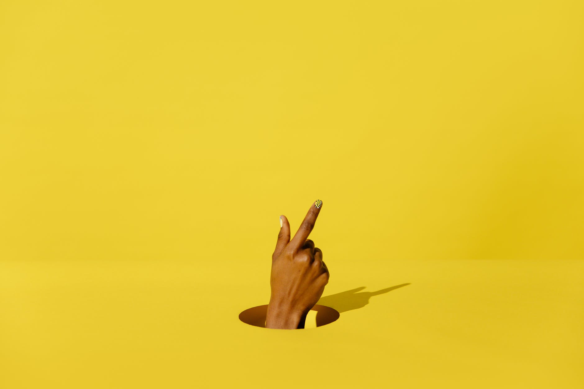 persons hand on yellow surface